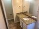 Bathroom featuring single vanity with granite countertop and patterned tile floors, offering style and functionality at 5000 Saxony Ct, Stone Mountain, GA 30083