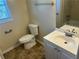 Bright bathroom with a white vanity, tile flooring, and classic fixtures at 5000 Saxony Ct, Stone Mountain, GA 30083
