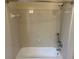Bathroom featuring a shower and bathtub with white tile surround at 5000 Saxony Ct, Stone Mountain, GA 30083