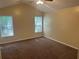 Bright bedroom with vaulted ceiling, two windows letting in plenty of natural light, and plush carpeting at 5000 Saxony Ct, Stone Mountain, GA 30083