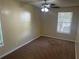 Cozy bedroom featuring a ceiling fan, neutral walls, and carpet flooring and a window provides natural lighting at 5000 Saxony Ct, Stone Mountain, GA 30083