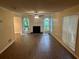 Spacious living room with lots of natural light, wood floors, and a cozy fireplace at 5000 Saxony Ct, Stone Mountain, GA 30083