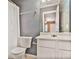Modern bathroom with white vanity, grey walls, and large mirror offers a clean and stylish space at 747 Gardenside Se Cir, Marietta, GA 30067
