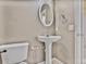 Compact bathroom features a pedestal sink and neutral tones, offering a functional and clean space at 747 Gardenside Se Cir, Marietta, GA 30067