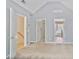 Carpeted bedroom with open doors to the staircase, closet, and ensuite bathroom creates a connected space at 747 Gardenside Se Cir, Marietta, GA 30067