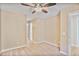 Carpeted hallway with ceiling fan and access to ensuite bathroom features a simple design at 747 Gardenside Se Cir, Marietta, GA 30067