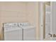 Bright laundry room featuring a modern washer and dryer with convenient shelving at 747 Gardenside Se Cir, Marietta, GA 30067