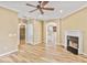 Spacious living room with wood floors, fireplace, ceiling fan, and an open floor plan to the kitchen at 747 Gardenside Se Cir, Marietta, GA 30067