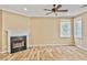 Inviting living room features a cozy fireplace, ceiling fan and bright windows, perfect for relaxing and entertaining at 747 Gardenside Se Cir, Marietta, GA 30067