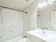 Clean bathroom features white tiled shower-tub and vanity with large mirror at 296 Water Oak Pl, Alpharetta, GA 30009