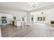 Bright open-concept living space features wood floors, fireplace, recessed lighting, and seamless flow to dining and kitchen at 296 Water Oak Pl, Alpharetta, GA 30009