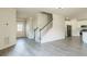 Bright living space featuring wood floors, neutral walls, and a staircase leading to the upper level at 296 Water Oak Pl, Alpharetta, GA 30009