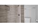 Stand-up shower features a rainfall shower head and tiled wall with inset storage shelving at 2972 Parc Lorraine, Lithonia, GA 30038