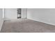 Open concept room with light grey carpeting and paint that extends into the nearby bathroom area at 2972 Parc Lorraine, Lithonia, GA 30038