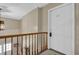 Hallway featuring an entry door and wood railing overlooking the lower floor at 2972 Parc Lorraine, Lithonia, GA 30038