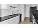 Modern kitchen featuring white cabinetry, stainless steel appliances, and sleek black countertops at 2972 Parc Lorraine, Lithonia, GA 30038