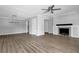 Open living area with modern light fixture, neutral walls, and view of fireplace in the adjacent room at 2972 Parc Lorraine, Lithonia, GA 30038