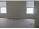 Clean bedroom featuring neutral carpet and natural light from two windows at 2975 Wintercrest Trce, Dunwoody, GA 30360