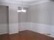 Dining room with hardwood flooring and wainscotting and a hanging light fixture at 2975 Wintercrest Trce, Dunwoody, GA 30360