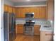 Efficient kitchen featuring stainless steel appliances, granite counters and light wood cabinetry at 2975 Wintercrest Trce, Dunwoody, GA 30360