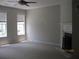 A bright living room featuring neutral carpet, a ceiling fan, and a fireplace with marble surround at 2975 Wintercrest Trce, Dunwoody, GA 30360