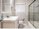 Well-lit bathroom boasts a sleek vanity with ample counter space and a shower-tub with glass doors at 86 Stratford Nw Dr, Atlanta, GA 30311