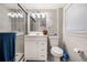 Bathroom with walk-in shower, white vanity, framed mirror, and a toilet with gray-painted walls at 86 Stratford Nw Dr, Atlanta, GA 30311