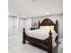 Bedroom featuring neutral walls, tiled floors, and large bed with decorative headboard and side table at 86 Stratford Nw Dr, Atlanta, GA 30311