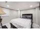 Bedroom featuring neutral walls, tiled floors, a large bed with padded headboard, and a window at 86 Stratford Nw Dr, Atlanta, GA 30311