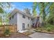 Exterior side and backyard elevation with painted brick, wood deck stairs, small garden area, and perimeter fence at 86 Stratford Nw Dr, Atlanta, GA 30311