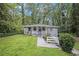 Charming one-story home with a welcoming front yard and walkway, surrounded by mature trees and green foliage at 86 Stratford Nw Dr, Atlanta, GA 30311