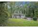Inviting one-story house with a well-maintained lawn and landscaped garden, nestled among lush trees at 86 Stratford Nw Dr, Atlanta, GA 30311