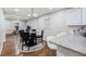 Bright kitchen and dining area with hardwood floors and modern finishes creates an inviting, open-concept living space at 86 Stratford Nw Dr, Atlanta, GA 30311
