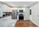 Spacious kitchen boasts stainless steel appliances, white cabinets, and granite countertops offering a modern style at 86 Stratford Nw Dr, Atlanta, GA 30311