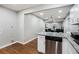 View of kitchen featuring stainless steel dishwasher, granite countertops, and white cabinetry offers an inviting space at 86 Stratford Nw Dr, Atlanta, GA 30311