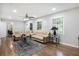 Hardwood floors enhance this bright living room with a ceiling fan, open to other living areas at 86 Stratford Nw Dr, Atlanta, GA 30311