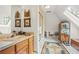 Bright bathroom featuring a skylight, wooden accents, and a charming vanity area at 1500 Historic Vw, Stone Mountain, GA 30087
