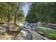 Scenic creek bed through lush trees and foliage on a sunny day at 1500 Historic Vw, Stone Mountain, GA 30087