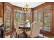 Bright dining area with wooden table, tufted chairs, and large windows at 1500 Historic Vw, Stone Mountain, GA 30087