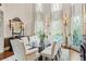 Elegant dining room with glass-top table, floor-to-ceiling windows, and ornate details at 1500 Historic Vw, Stone Mountain, GA 30087