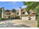 A beautiful home with a large driveway, three-car garage, and rear-facing balcony at 1500 Historic Vw, Stone Mountain, GA 30087