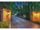 Grand stone gated entrance with lanterns illuminating the driveway to the home at 1500 Historic Vw, Stone Mountain, GA 30087