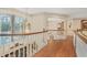 Bright hallway featuring hardwood floors, white railings, and a large stained glass window at 1500 Historic Vw, Stone Mountain, GA 30087