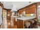 Well-lit kitchen with wood cabinets, an island with seating, and hardwood floors at 1500 Historic Vw, Stone Mountain, GA 30087