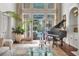 Sunlit living room featuring a grand piano, large windows, and view of the outdoor pool at 1500 Historic Vw, Stone Mountain, GA 30087