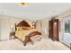 Serene main bedroom with a decorative bed frame, private balcony access, and ample natural light at 1500 Historic Vw, Stone Mountain, GA 30087