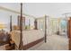 Luxurious main bedroom with four-poster bed and sitting area near bright windows at 1500 Historic Vw, Stone Mountain, GA 30087