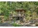 Wooden pavilion overlooking creek and woods, featuring stairs and wooden railing at 1500 Historic Vw, Stone Mountain, GA 30087