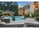 Inviting backyard pool with cabana, lounging area and manicured landscaping at 1500 Historic Vw, Stone Mountain, GA 30087