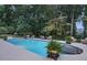 Inviting in-ground pool featuring a built-in hot tub, luxurious furniture, and lush landscaping at 1500 Historic Vw, Stone Mountain, GA 30087
